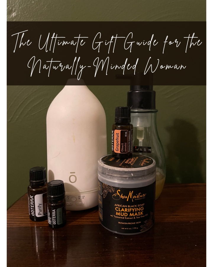 A diffuser, oils, and a clay face mask on a table with the words "The Ultimate Gift Guide for the Naturally-Minded Woman"